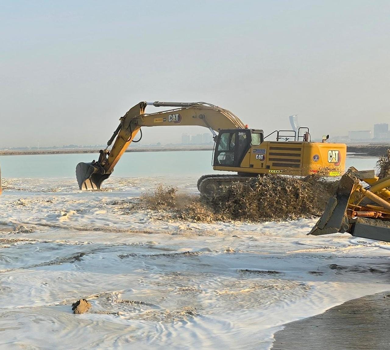 Long-reach excavator working a marine reclamation site